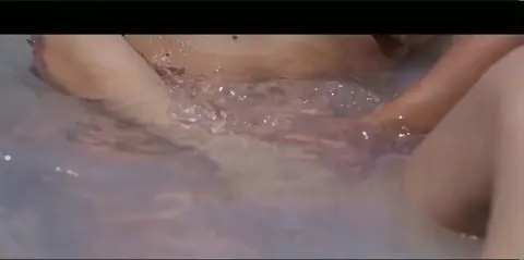 Two Girls Dance and Kiss to Music in Bedroom